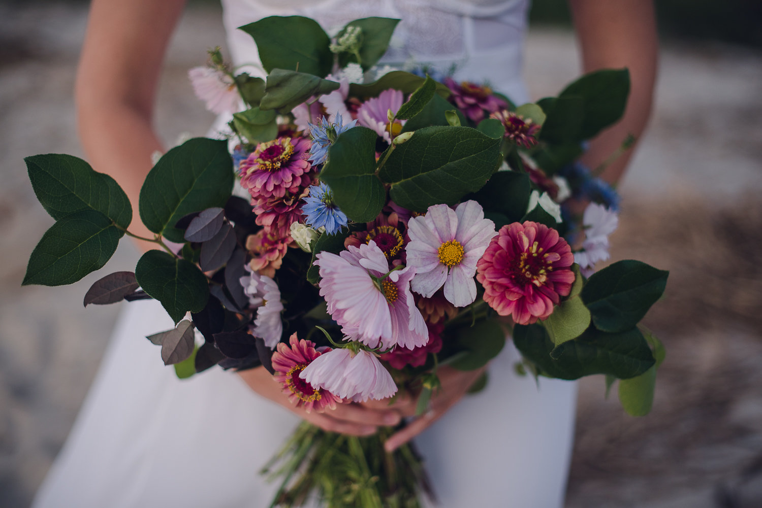 Artfully designed wedding table setup featuring organic floral centerpieces and coastal decor